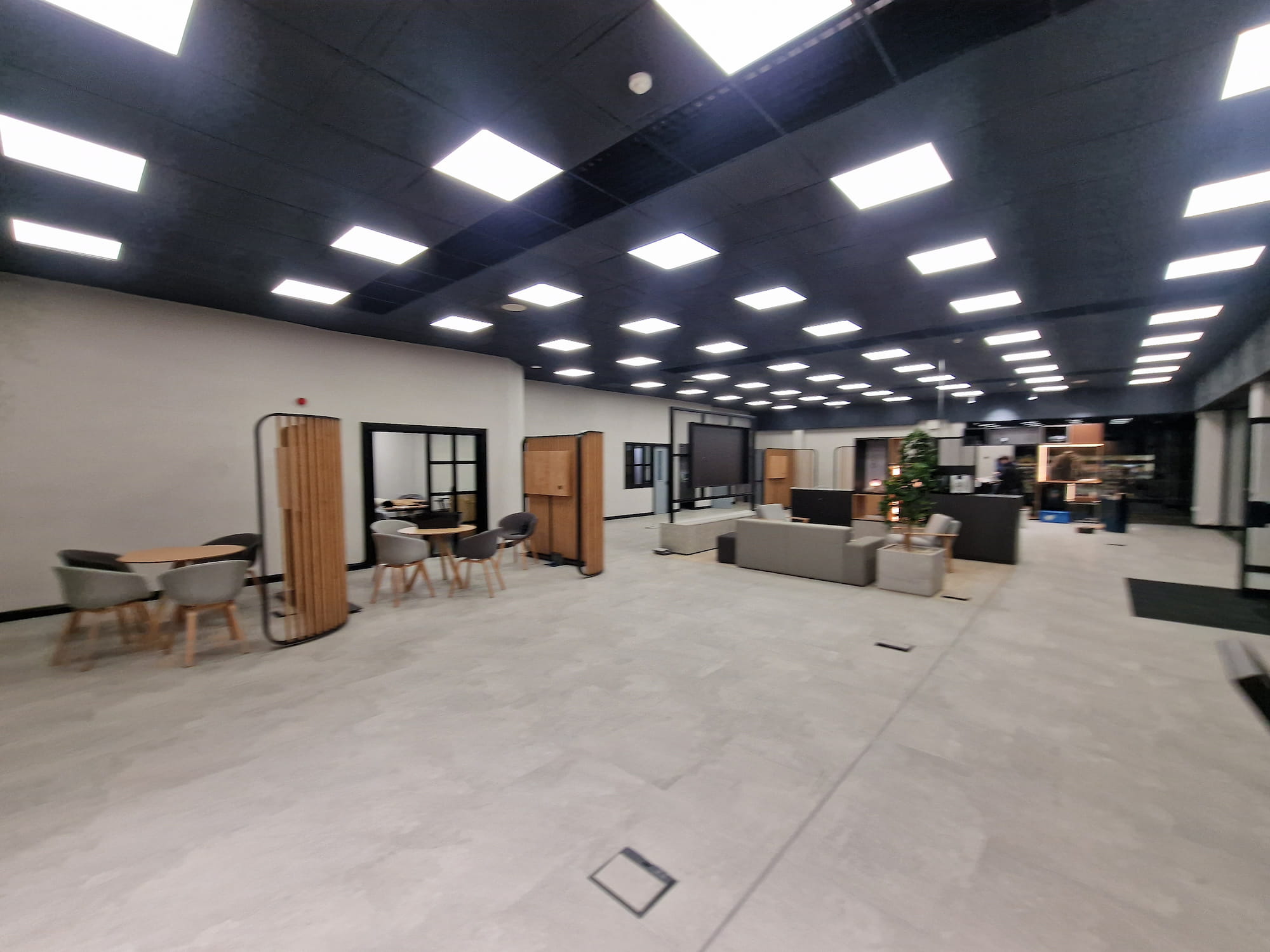 Finished commercial showroom with painted walls and dark ceiling